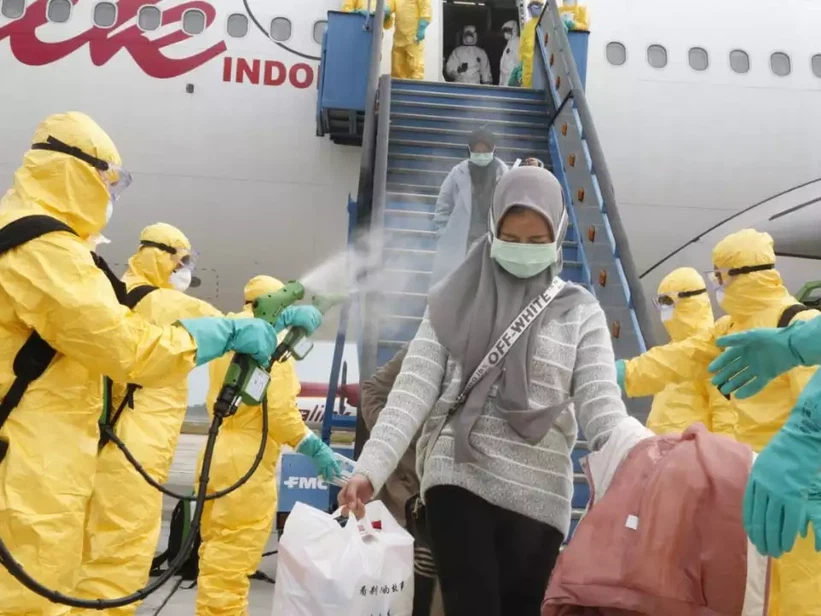 photos-and-videos-show-officials-in-hazmat-suits-spraying-passengers-with-mist-as-they-arrive-in-indonesia-amid-coronavirus-scare